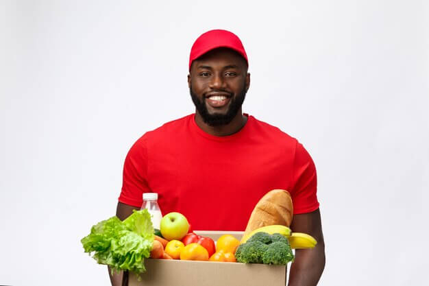 delivery-service-handsome-african-american-delivery-man-carrying-package-box-grocery-food-drink-from-store_1258-39809